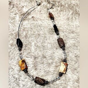 Necklace. Stones, shades of gray, black, brown.  Clear beads in between. 17“